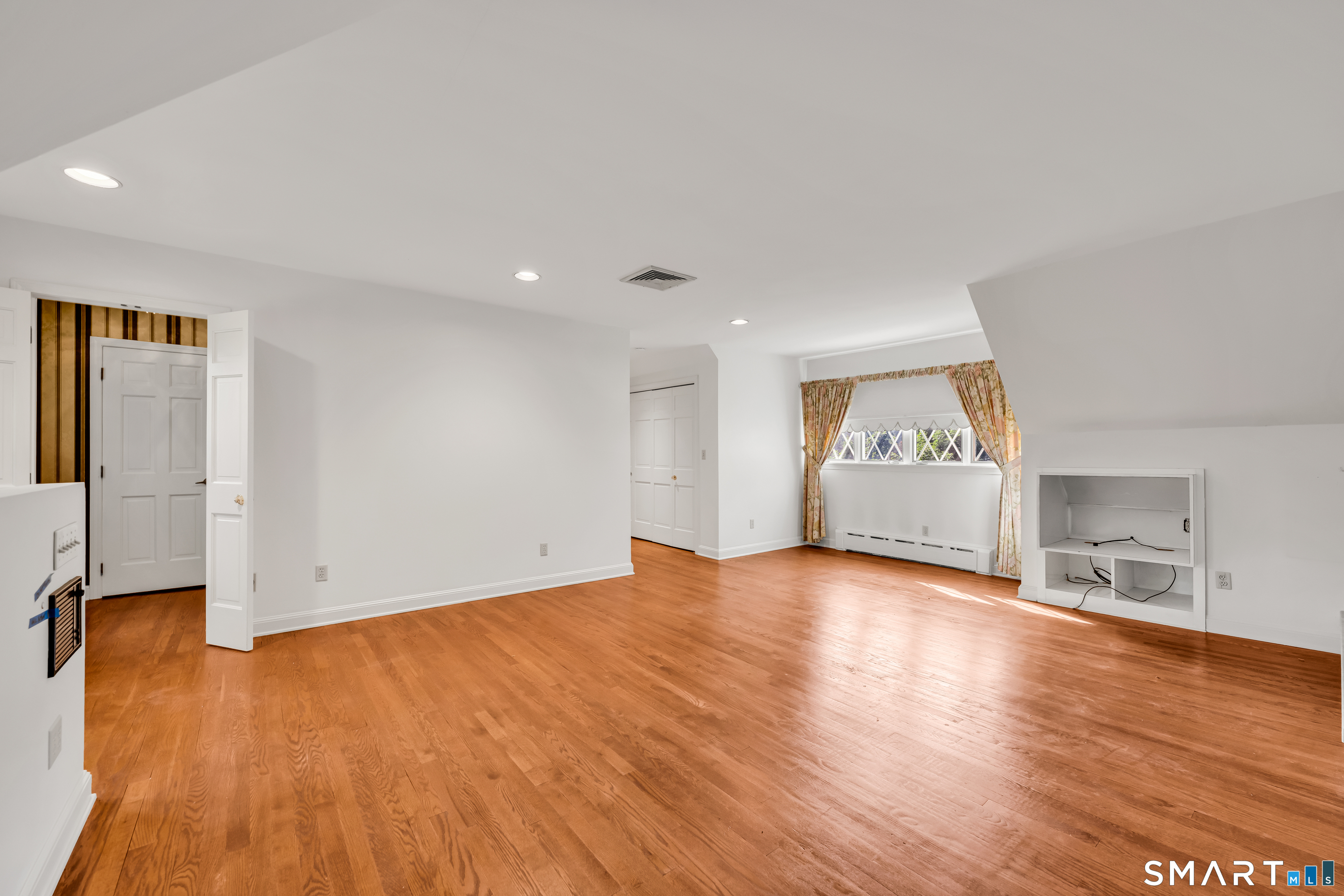 232 Maybrook Road Waterbury, CT 06708 - Photo 23 of 38 an empty room with wooden floor and a window