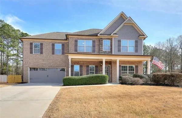 a front view of a house with a yard and garage