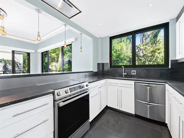 a kitchen with a stove microwave and sink