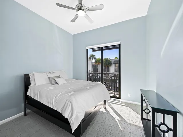a bedroom with a bed lamp and a window