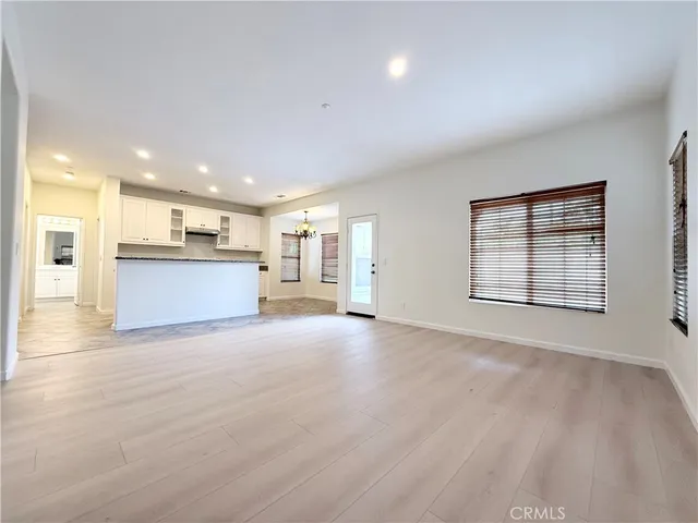 a view of a kitchen with a sink and a large window
