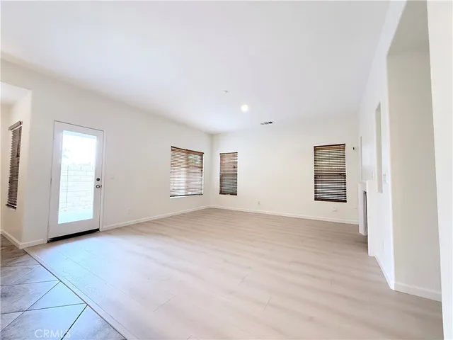 an empty room with windows and closet