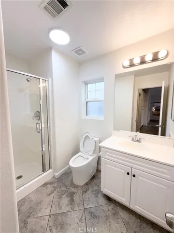 a bathroom with a sink toilet a mirror and shower
