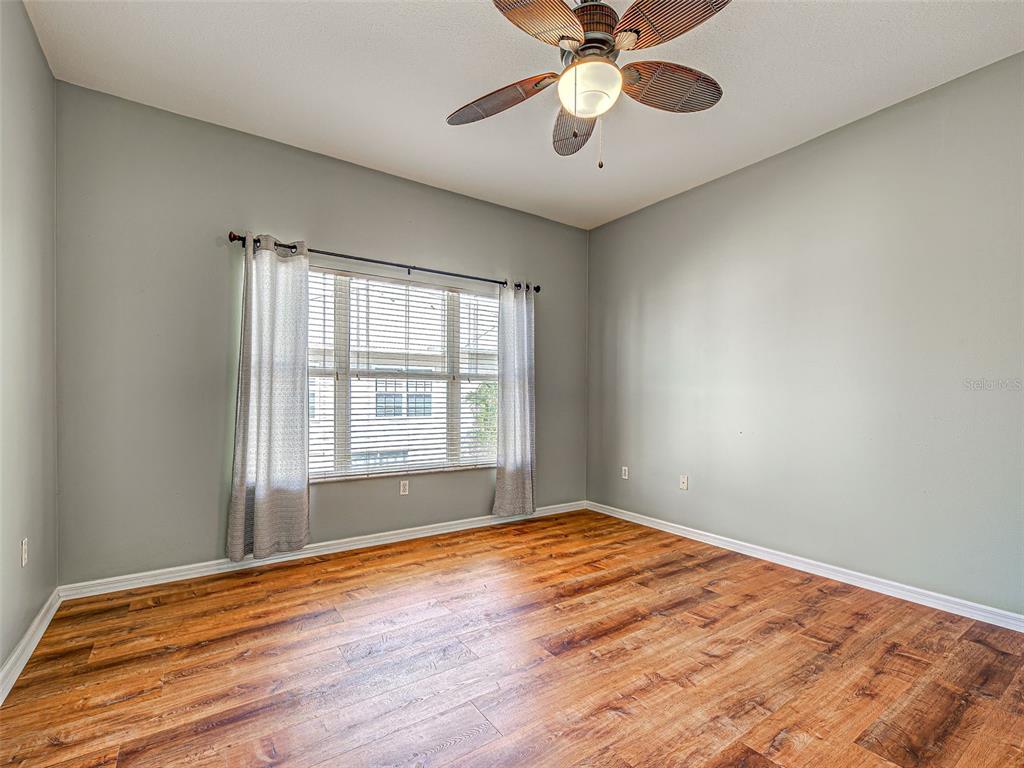 1801 Highland Road Osprey, FL 34229 - Photo 19 of 40 a view of an empty room with window and a chandelier fan