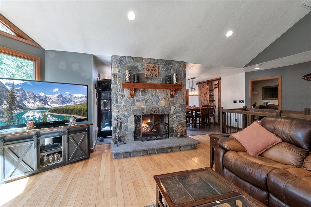 124 Wood Hill Road Monson, MA 01057 - Photo 11 of 41 a living room with furniture a flat screen tv and a fireplace
