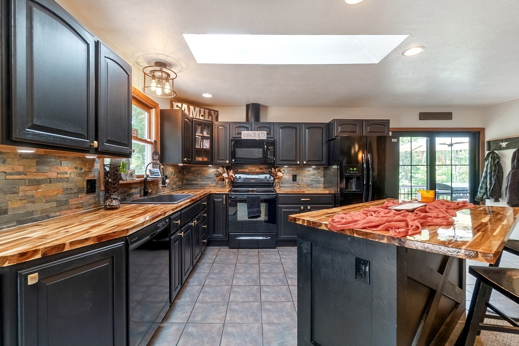 124 Wood Hill Road Monson, MA 01057 - Photo 12 of 41 a kitchen with stainless steel appliances granite countertop a sink and a refrigerator