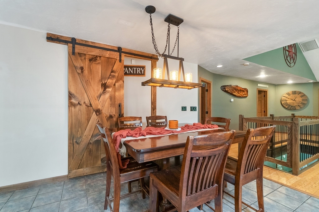 124 Wood Hill Road Monson, MA 01057 - Photo 16 of 41 a view of a dining room and livingroom with furniture wooden floor a chandelier