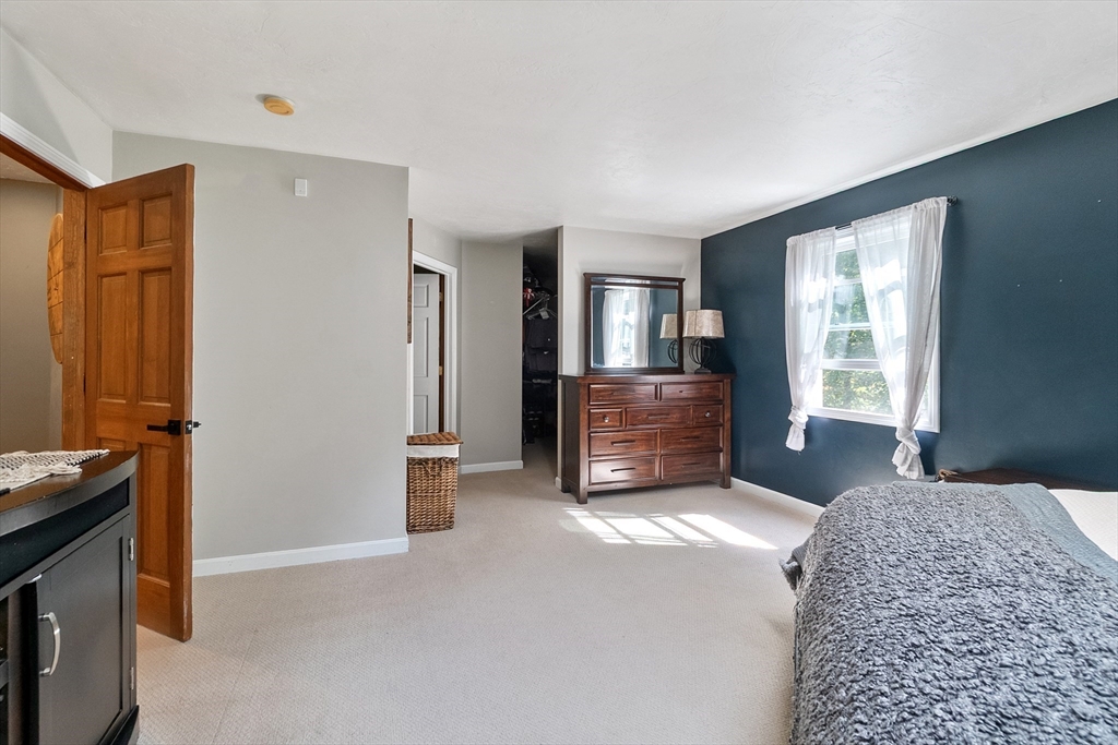 124 Wood Hill Road Monson, MA 01057 - Photo 19 of 41 a spacious bedroom with a bed and a cabinets