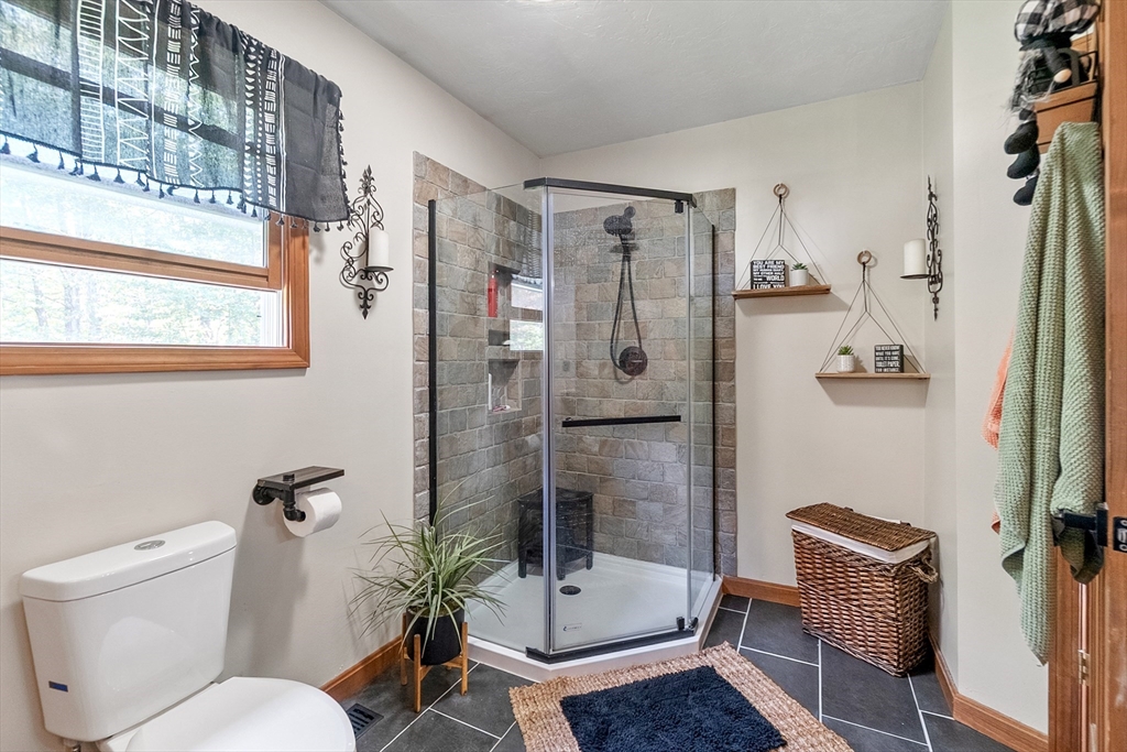 124 Wood Hill Road Monson, MA 01057 - Photo 21 of 41 a bathroom with a shower a toilet and a sink