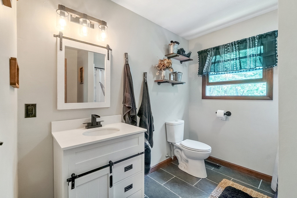124 Wood Hill Road Monson, MA 01057 - Photo 25 of 41 a bathroom with a sink toilet and mirror