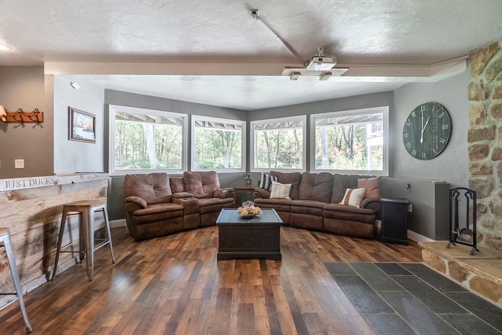 124 Wood Hill Road Monson, MA 01057 - Photo 26 of 41 a living room with furniture a large window and a chandelier