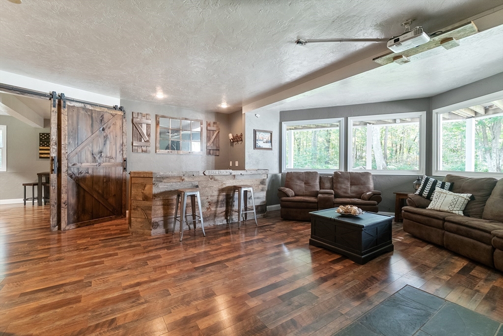 124 Wood Hill Road Monson, MA 01057 - Photo 27 of 41 a living room with furniture and a large window