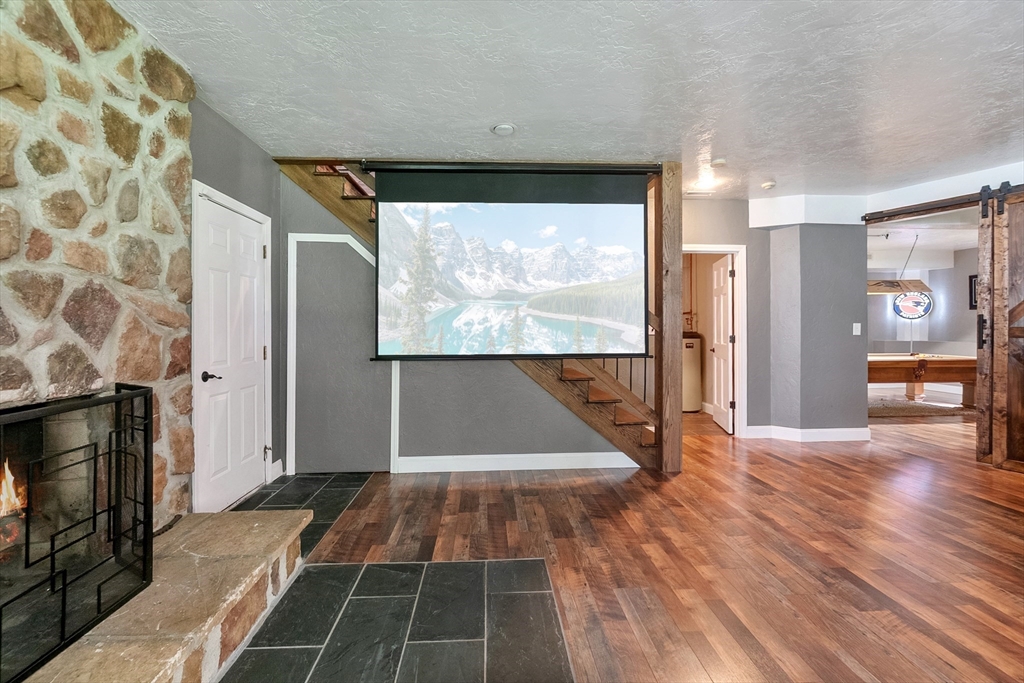 124 Wood Hill Road Monson, MA 01057 - Photo 29 of 41 a view of empty room with wooden floor and fireplace