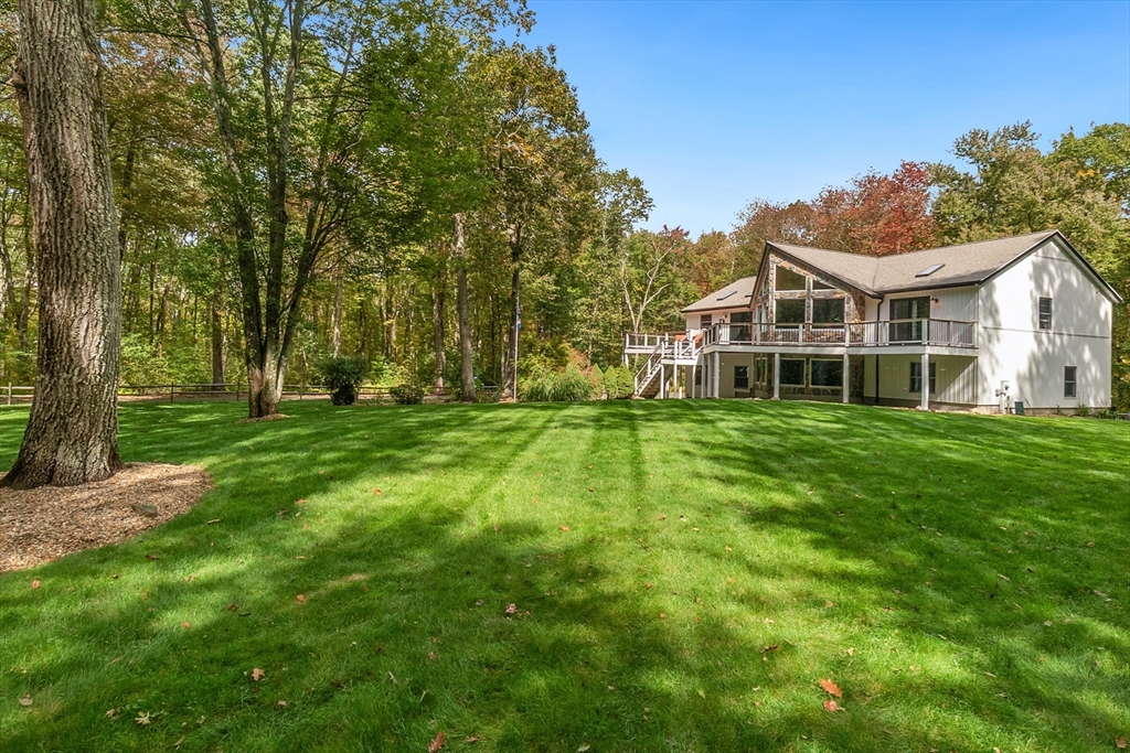 124 Wood Hill Road Monson, MA 01057 - Photo 3 of 41 a view of a house with a big yard and large trees