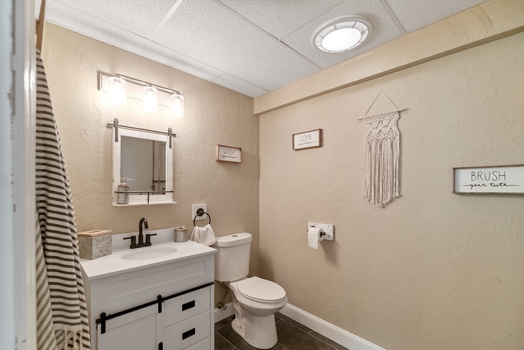 124 Wood Hill Road Monson, MA 01057 - Photo 33 of 41 a bathroom with a sink a toilet and mirror