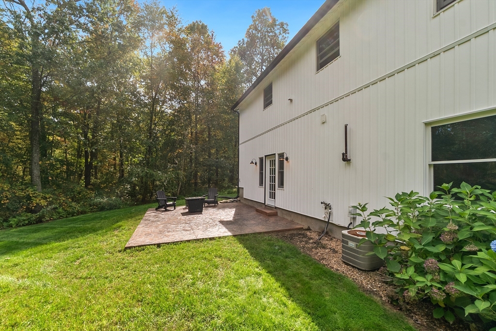 124 Wood Hill Road Monson, MA 01057 - Photo 39 of 41 a backyard of a house with table and chairs