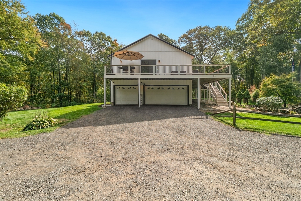 124 Wood Hill Road Monson, MA 01057 - Photo 40 of 41 a front view of a house with a yard and garage