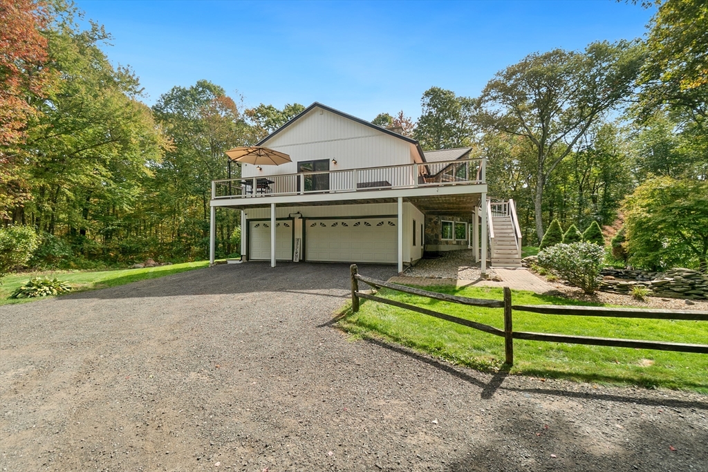 124 Wood Hill Road Monson, MA 01057 - Photo 41 of 41 a view of a house with a yard and sitting area