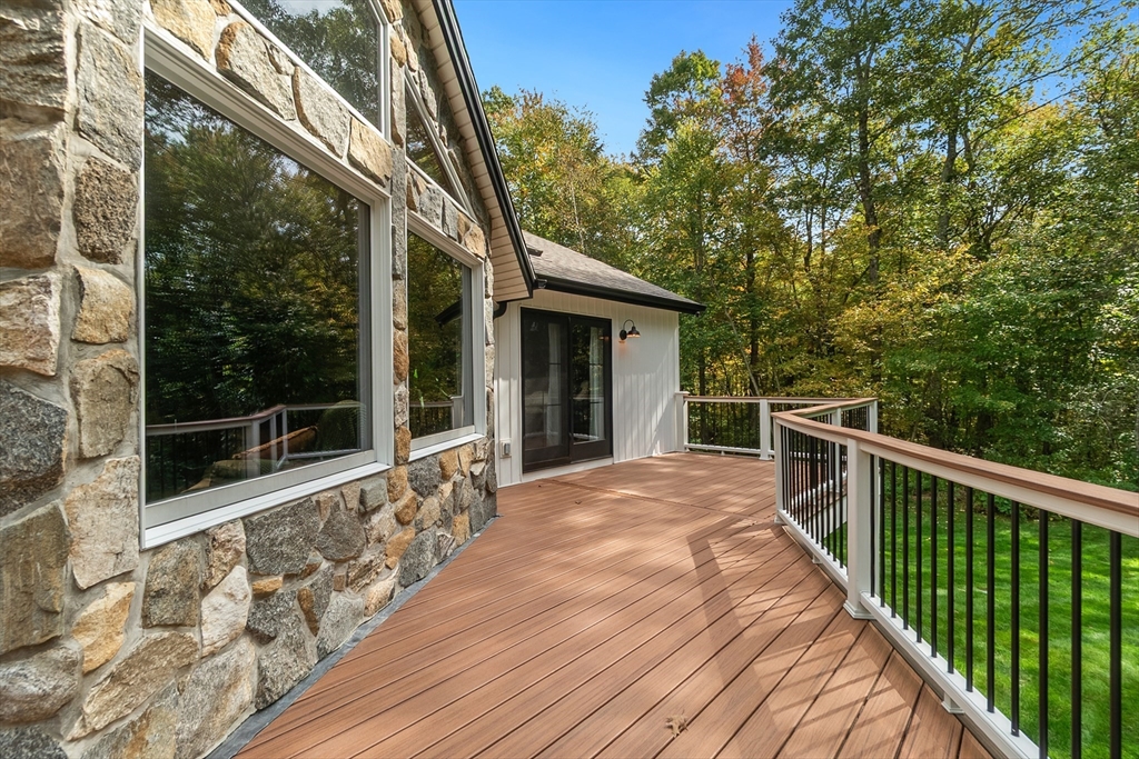 124 Wood Hill Road Monson, MA 01057 - Photo 6 of 41 a view of backyard with large trees and wooden fence