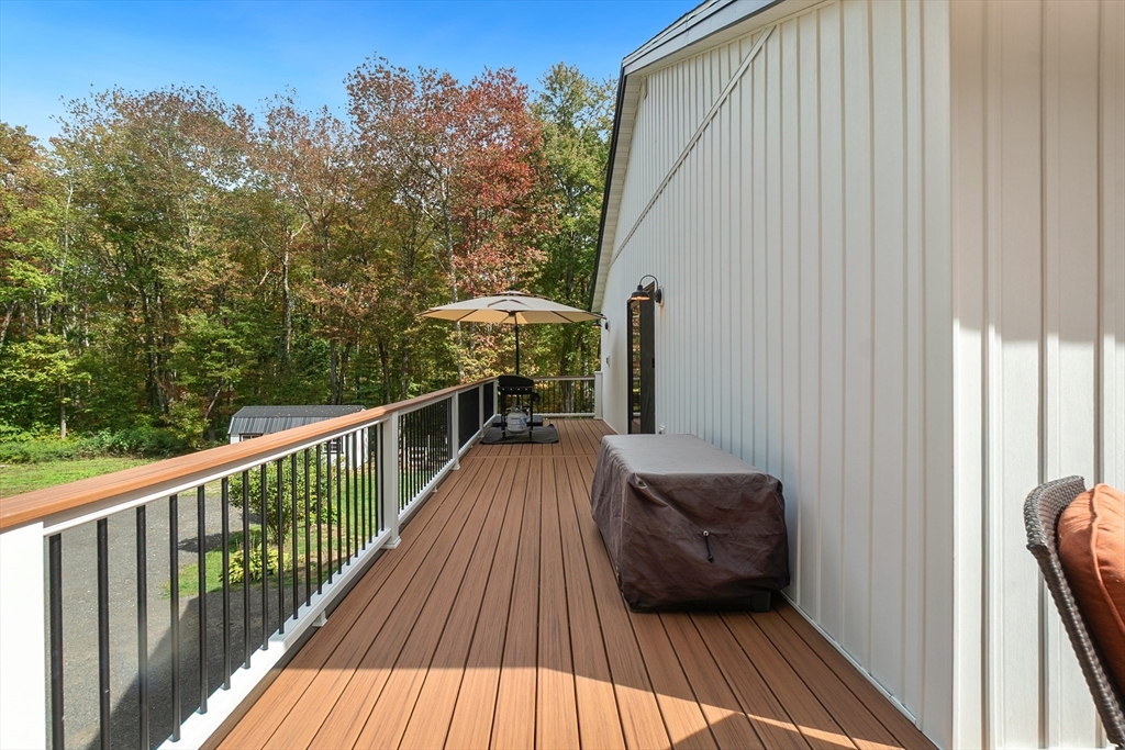 124 Wood Hill Road Monson, MA 01057 - Photo 7 of 41 a view of balcony with couch and trees