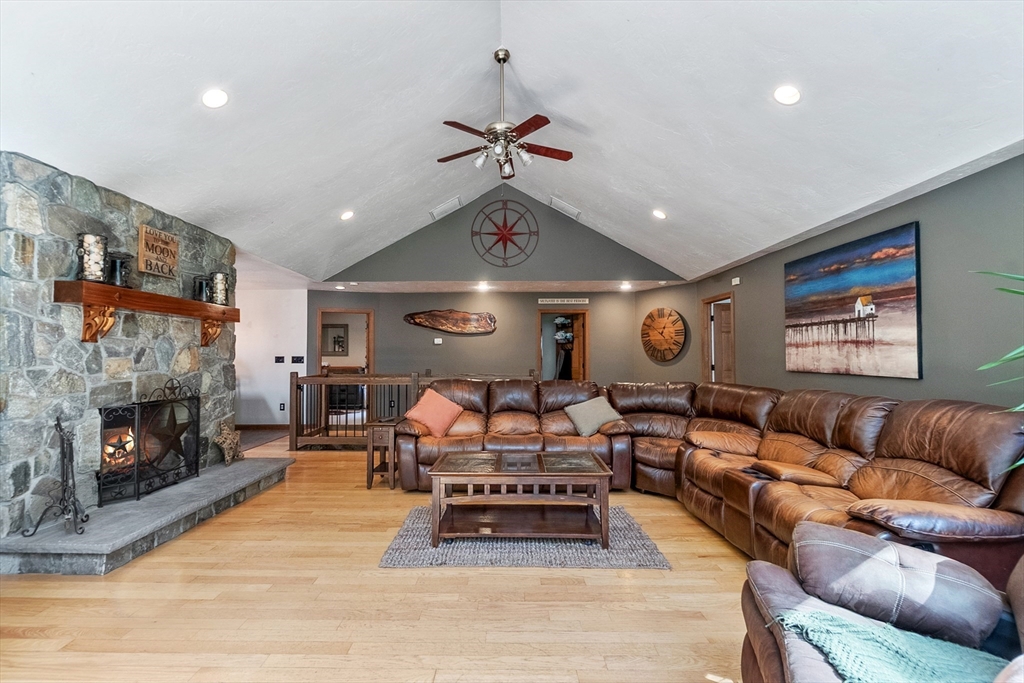 124 Wood Hill Road Monson, MA 01057 - Photo 10 of 41 a living room with furniture ceiling fan and a fireplace