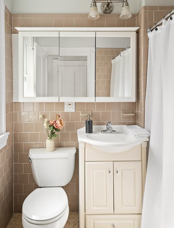 50 Beacon Street, Unit 3 Somerville, MA 02143 - Photo 11 of 15 a bathroom with a granite countertop toilet sink and mirror