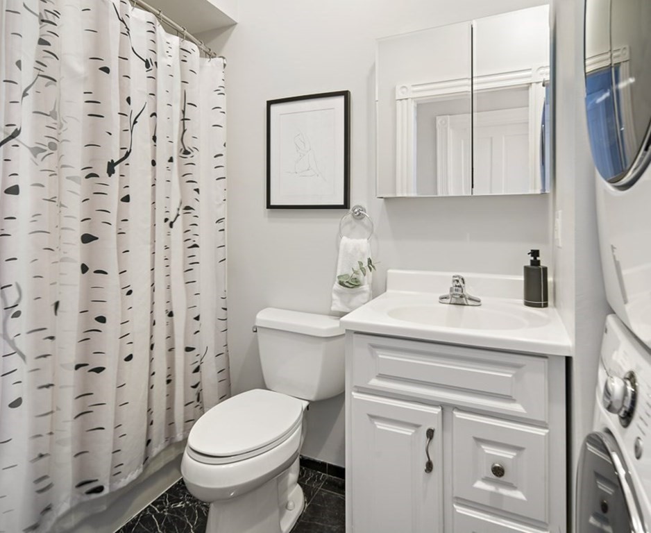 50 Beacon Street, Unit 3 Somerville, MA 02143 - Photo 12 of 15 a bathroom with a sink a toilet and a mirror