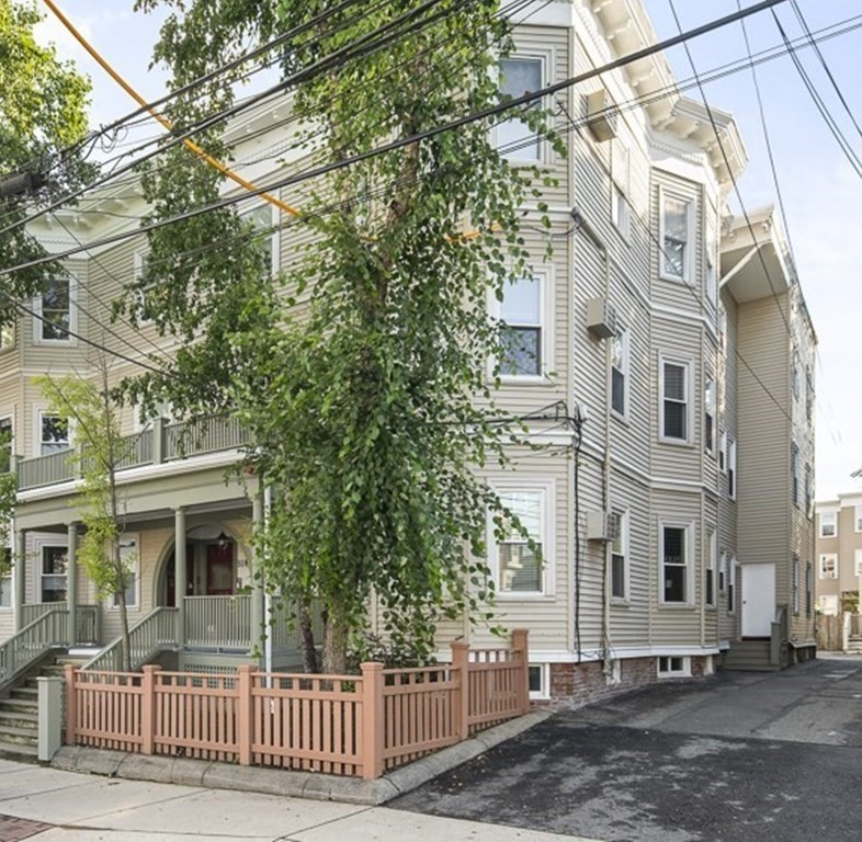 50 Beacon Street, Unit 3 Somerville, MA 02143 - Photo 14 of 15 a front view of a house with a iron fence