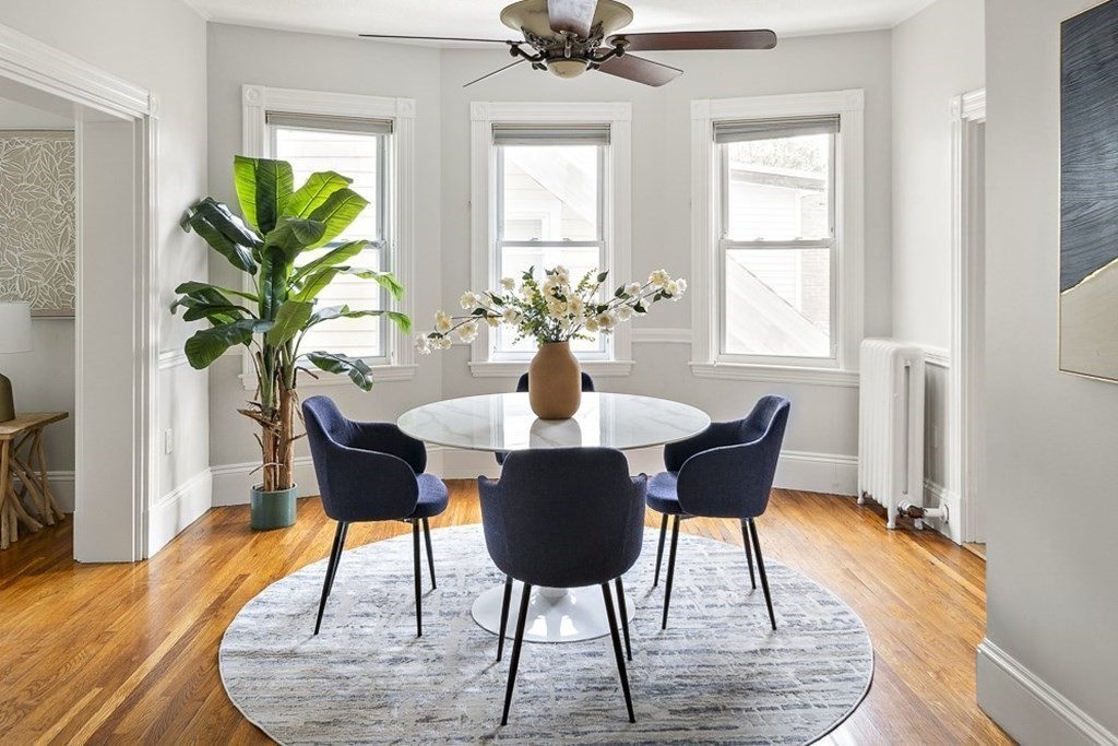 50 Beacon Street, Unit 3 Somerville, MA 02143 - Photo 5 of 15 a dining room with furniture potted plants and wooden floor