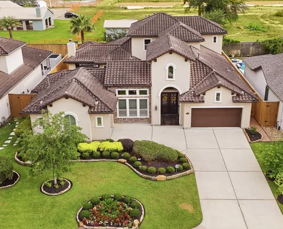 a aerial view of a house with table and chairs