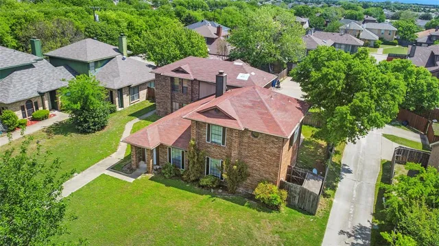 an aerial view of a house with a garden and outdoor seating