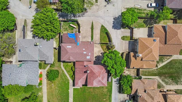 an aerial view of houses with yard