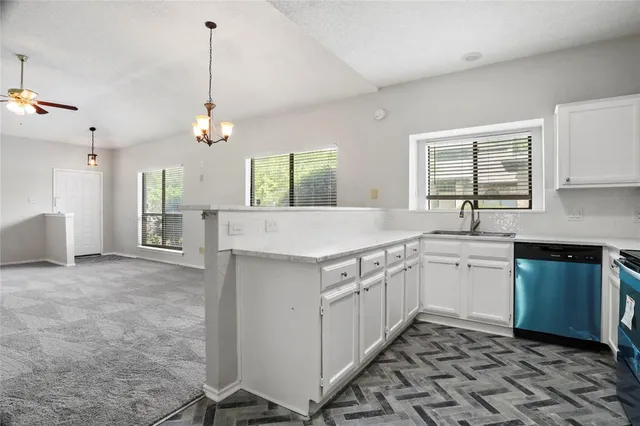 a kitchen with sink cabinets and window