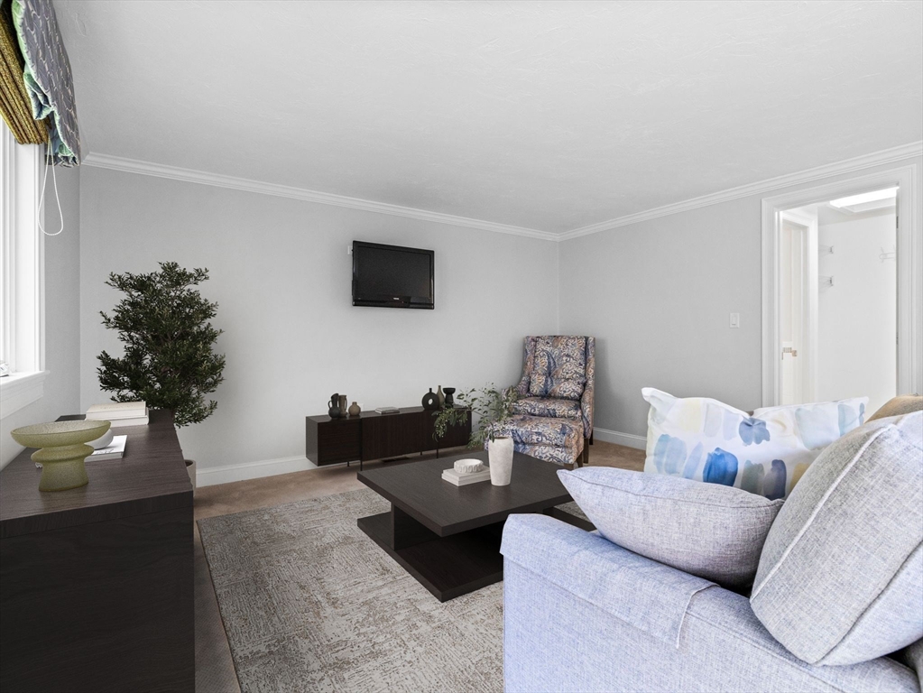 4 Farmer Road, Unit 4 Milton, MA 02186 - Photo 17 of 33 a living room with furniture and a flat screen tv