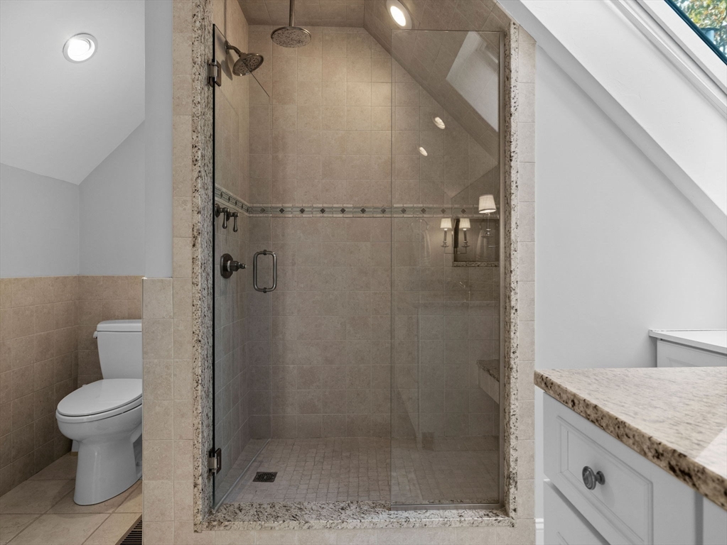 4 Farmer Road, Unit 4 Milton, MA 02186 - Photo 25 of 33 a bathroom with a granite countertop sink a toilet and shower