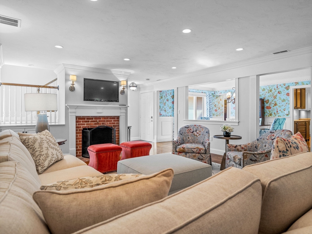 4 Farmer Road, Unit 4 Milton, MA 02186 - Photo 3 of 33 a living room with furniture a fireplace and a flat screen tv