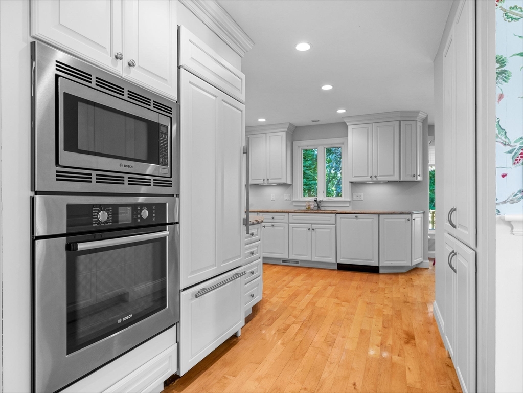 4 Farmer Road, Unit 4 Milton, MA 02186 - Photo 8 of 33 a kitchen with stainless steel appliances a stove a microwave and cabinets