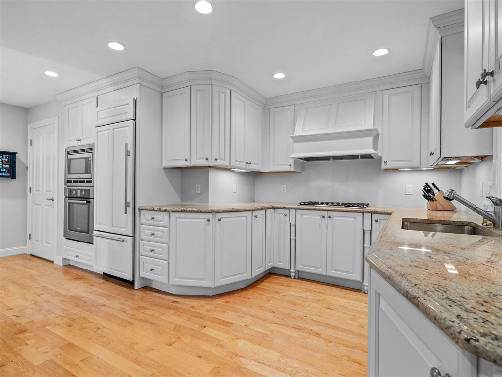 4 Farmer Road, Unit 4 Milton, MA 02186 - Photo 9 of 33 a kitchen with stainless steel appliances granite countertop a sink stove and cabinets