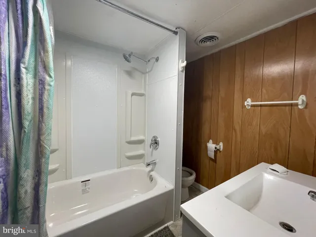 a bathroom with a tub and a sink