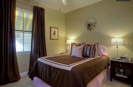 a bedroom with a bed and a night stand