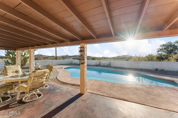a view of a swimming pool with an outdoor seating