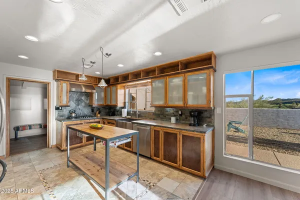 a kitchen with stainless steel appliances granite countertop a stove and a refrigerator
