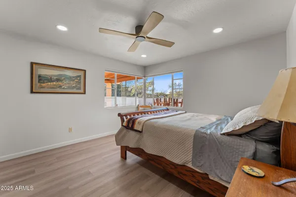 a bedroom with a bed and wooden floor