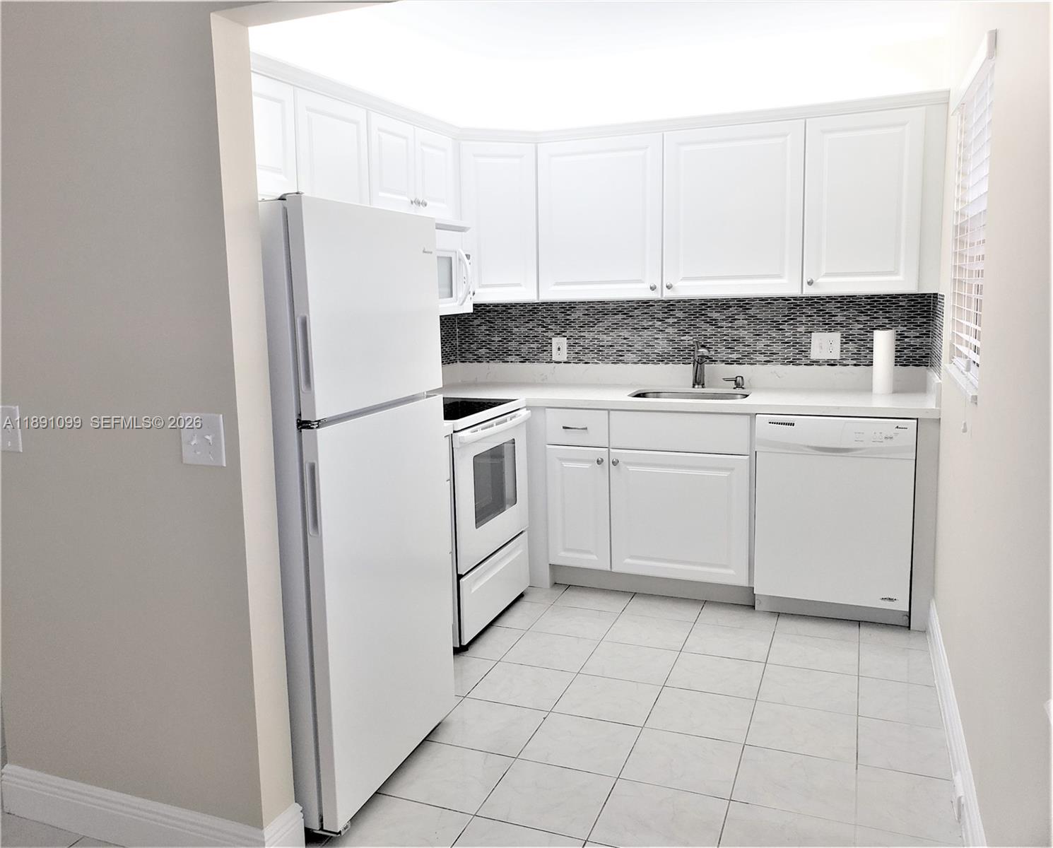 a white refrigerator freezer sitting inside of a kitchen