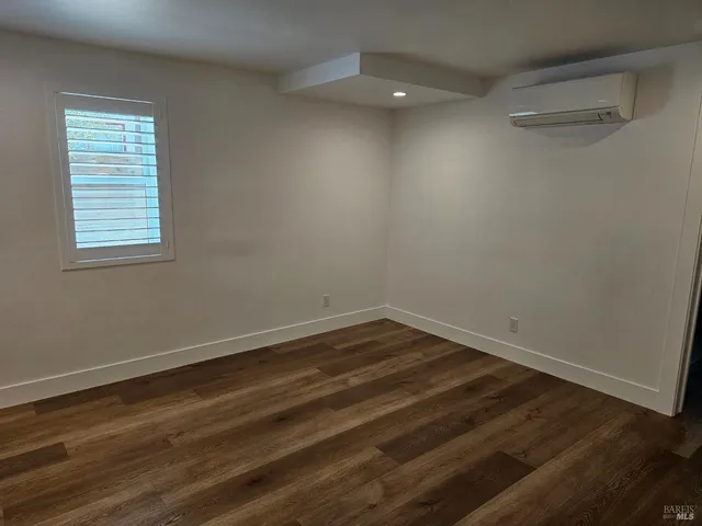 a view of a room with wooden floor and windows in it