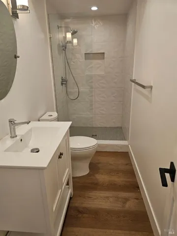 a bathroom with a sink a toilet and shower