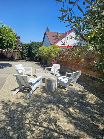 a view of a patio with a table and chairs