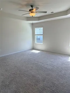 a view of room with a ceiling fan and window
