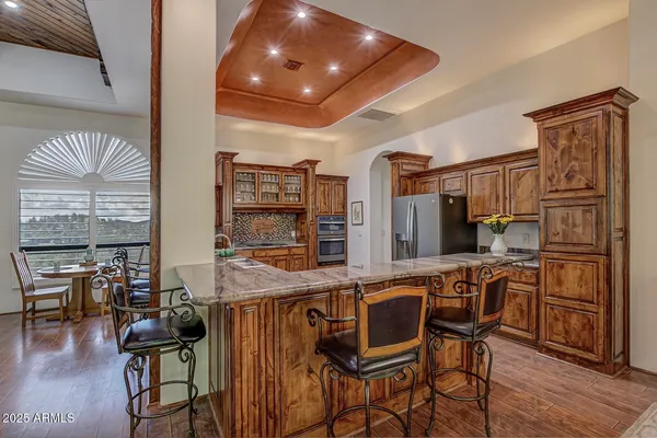 a kitchen with stainless steel appliances granite countertop a stove and cabinets