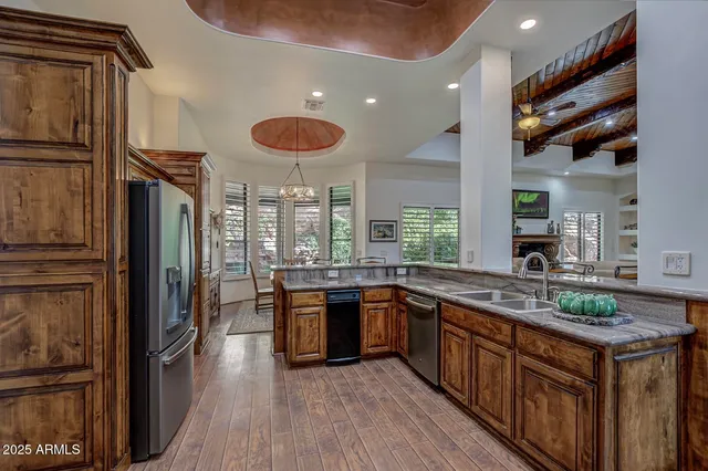 a open kitchen with stainless steel appliances granite countertop a stove refrigerator and cabinets